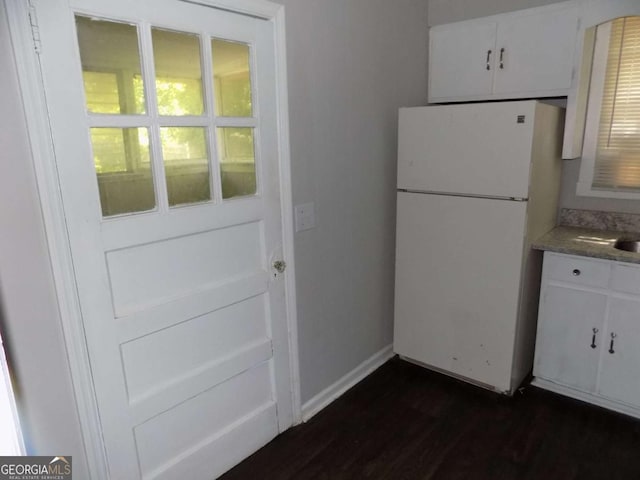 kitchen featuring white cabinetry, plenty of natural light, and white fridge