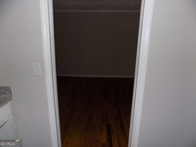 hallway with dark wood-type flooring