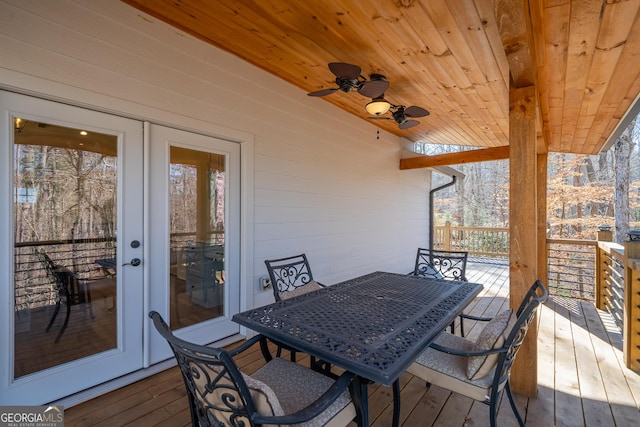 wooden deck with ceiling fan and french doors