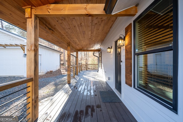 wooden deck featuring a porch and a garage