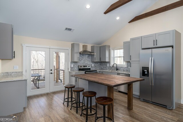 122 Acadia Dr Unit 110, Ellijay, GA 30540 - kitchen with butcher block countertops, visible vents, wall chimney exhaust hood, stainless steel appliances, and gray cabinets