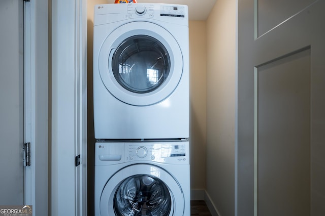 122 Acadia Dr Unit 110, Ellijay, GA 30540 - clothes washing area featuring stacked washer and clothes dryer, baseboards, and laundry area
