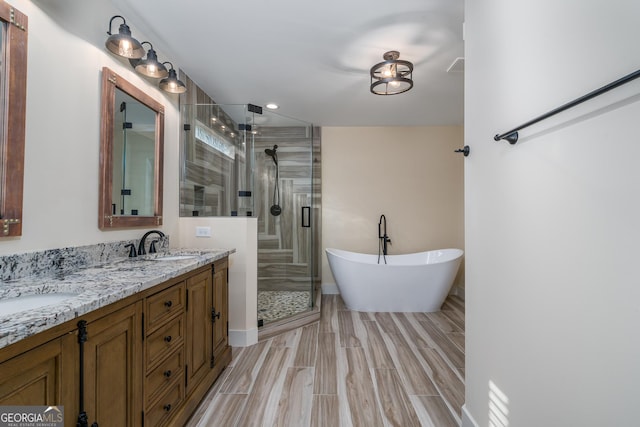 bathroom featuring vanity and shower with separate bathtub