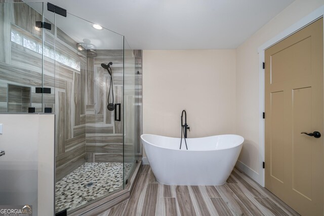 122 Acadia Dr Unit 110, Ellijay, GA 30540 - full bathroom featuring a soaking tub, wood tiled floor, and a shower stall