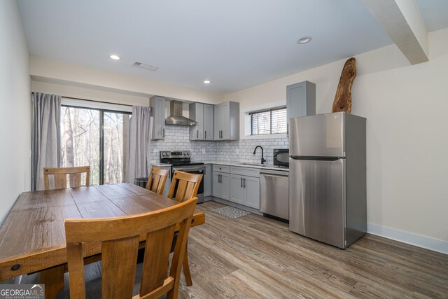 122 Acadia Dr Unit 110, Ellijay, GA 30540 - kitchen featuring visible vents, stainless steel appliances, a sink, wall chimney range hood, and gray cabinets
