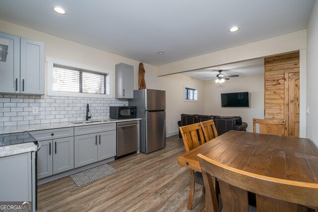 122 Acadia Dr Unit 110, Ellijay, GA 30540 - kitchen featuring decorative backsplash, ceiling fan, appliances with stainless steel finishes, a sink, and gray cabinets