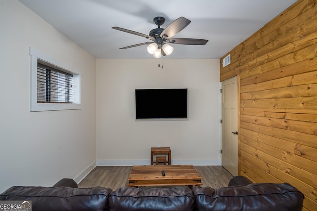 living room with ceiling fan and dark hardwood / wood-style flooring