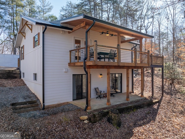 back of property featuring a balcony, ceiling fan, and a patio area