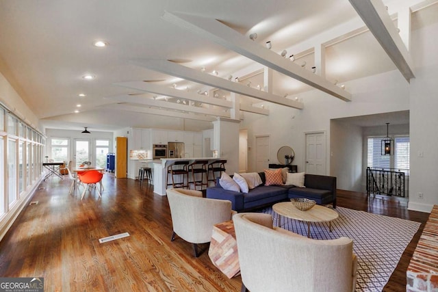 living room featuring hardwood / wood-style floors and lofted ceiling with beams