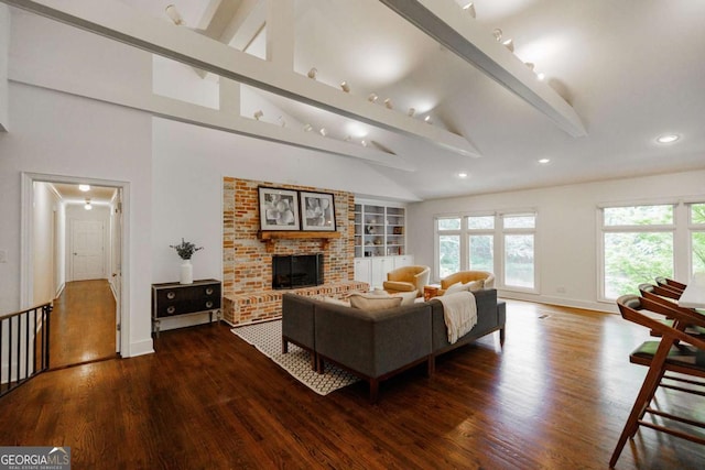 living room featuring beamed ceiling, a fireplace, high vaulted ceiling, and hardwood / wood-style flooring