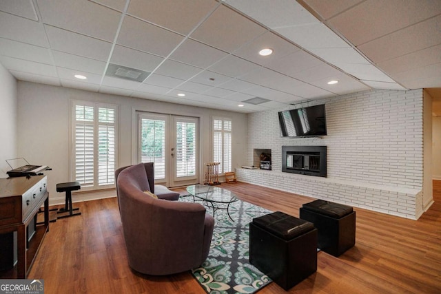 living room featuring hardwood / wood-style flooring, a healthy amount of sunlight, and a fireplace