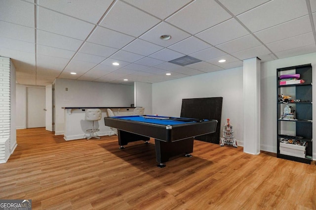 recreation room with a drop ceiling, hardwood / wood-style floors, and billiards