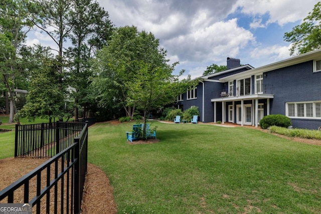 view of yard with a balcony