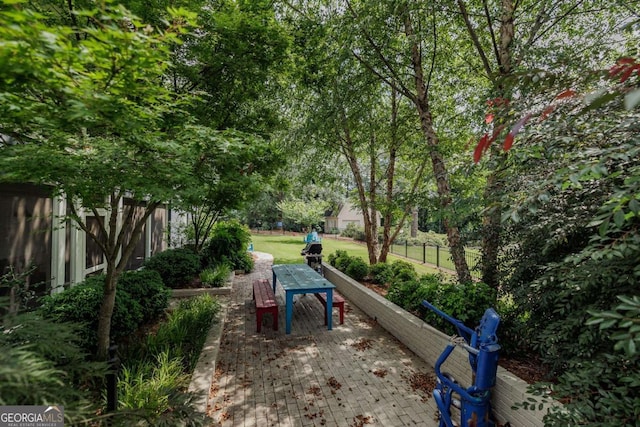 view of community featuring a patio and a lawn