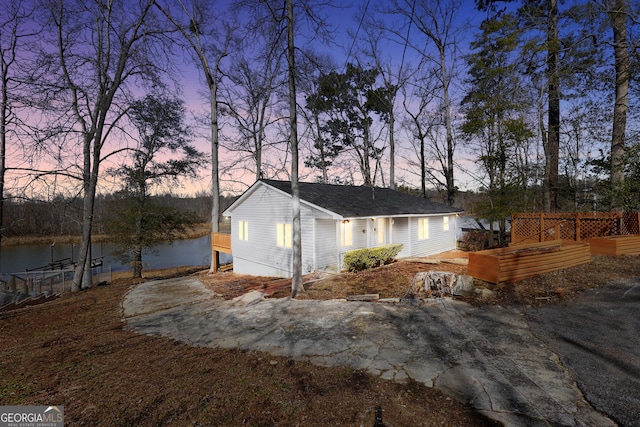 property exterior at dusk with a water view