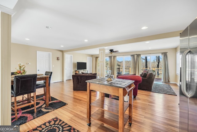 dining room featuring ceiling fan and light wood-type flooring