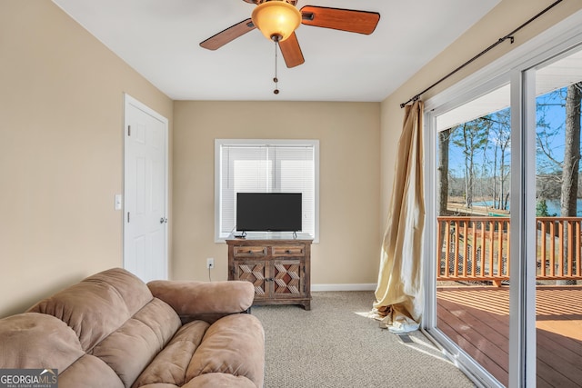 carpeted living room featuring ceiling fan