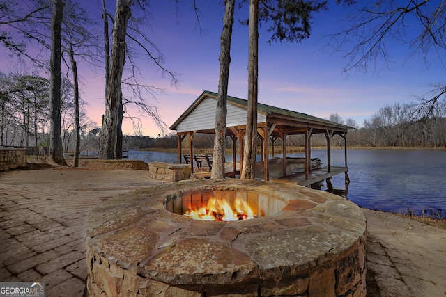 dock area featuring a gazebo, a water view, and a fire pit