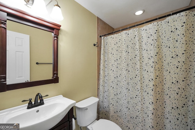 bathroom featuring vanity, toilet, and a shower with shower curtain