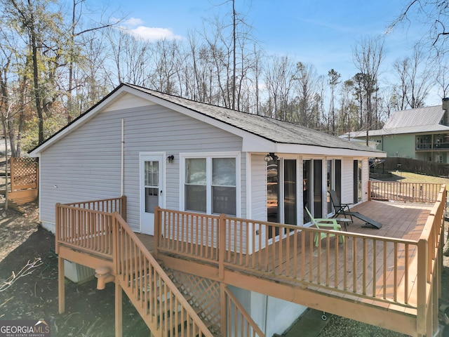 rear view of house featuring a wooden deck