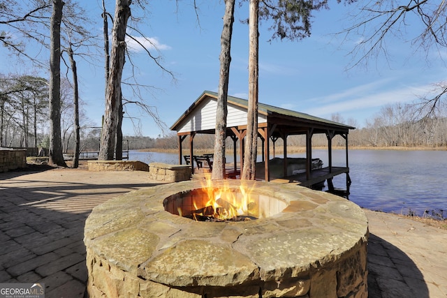 dock area with a fire pit, a gazebo, and a water view