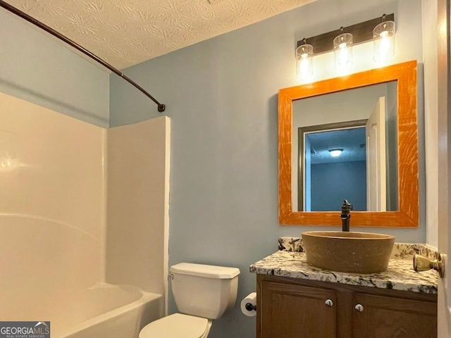 full bathroom featuring toilet, shower / washtub combination, vanity, and a textured ceiling