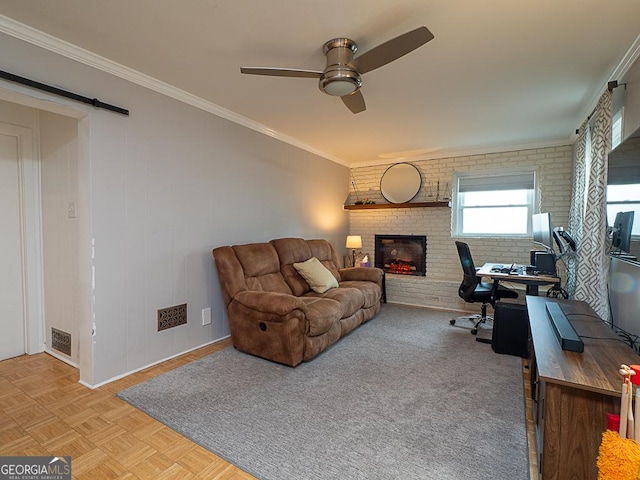 living room featuring brick wall, light parquet flooring, a fireplace, ceiling fan, and crown molding