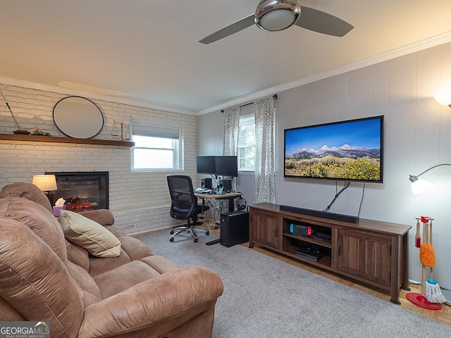 office area featuring ornamental molding, brick wall, ceiling fan, and a brick fireplace