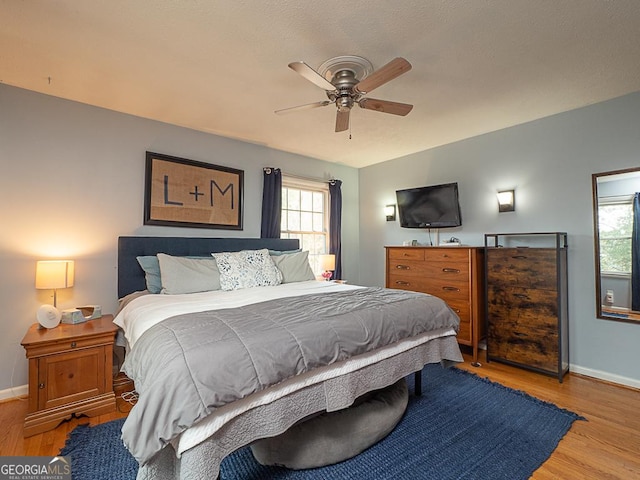 bedroom with ceiling fan and light wood-type flooring