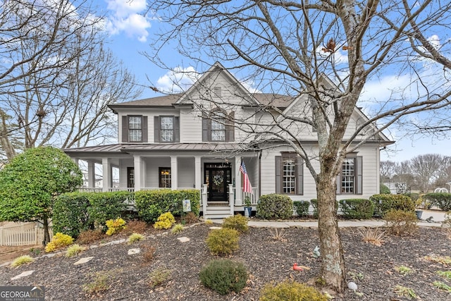 view of front of home with a porch, a standing seam roof, and metal roof