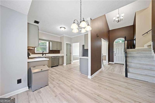 kitchen featuring pendant lighting, a notable chandelier, and dishwasher