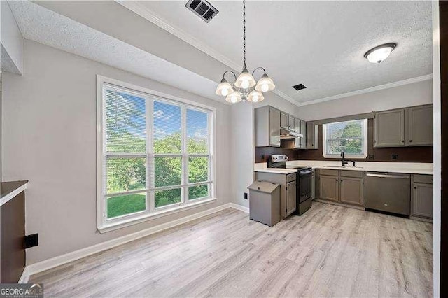 kitchen featuring sink, a textured ceiling, hanging light fixtures, light hardwood / wood-style flooring, and stainless steel appliances