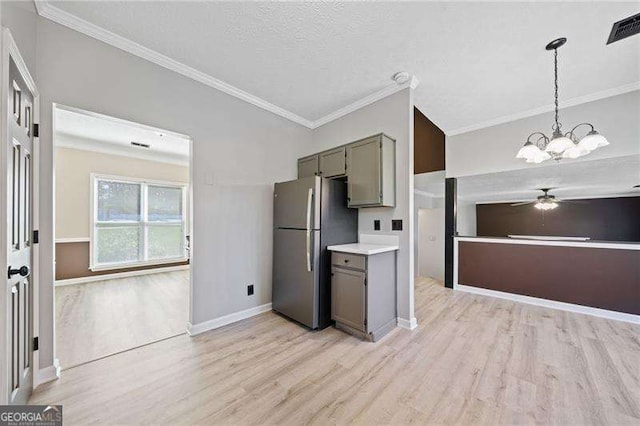 kitchen featuring hanging light fixtures, light hardwood / wood-style flooring, ornamental molding, and stainless steel refrigerator