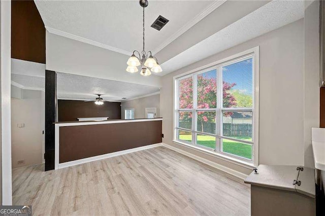 interior space with ornamental molding, pendant lighting, ceiling fan with notable chandelier, and light wood-type flooring