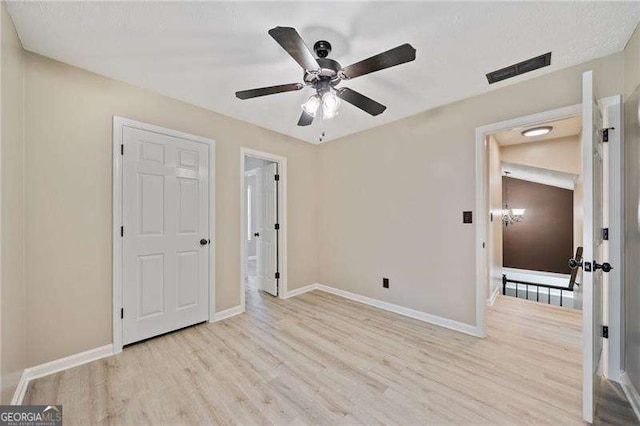 unfurnished bedroom with ceiling fan and light wood-type flooring