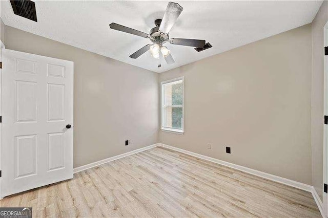 spare room with ceiling fan and light hardwood / wood-style floors