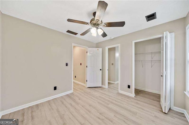 unfurnished bedroom with ceiling fan, a closet, and light wood-type flooring