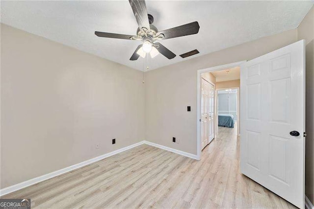 spare room featuring ceiling fan and light wood-type flooring