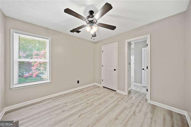 unfurnished bedroom featuring light hardwood / wood-style floors and ceiling fan