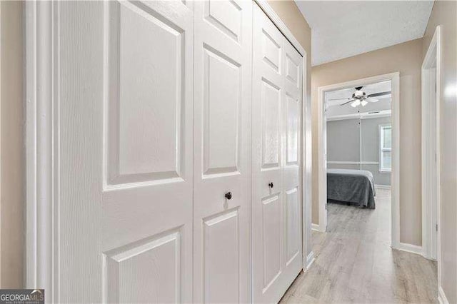 corridor with light hardwood / wood-style floors