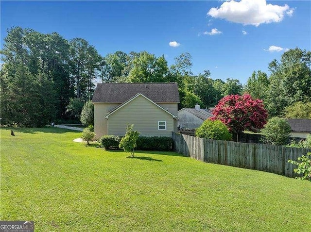 view of side of property with a yard