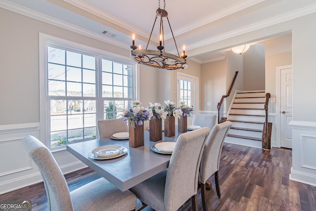 dining area with visible vents, wainscoting, dark wood-style flooring, stairs, and a chandelier