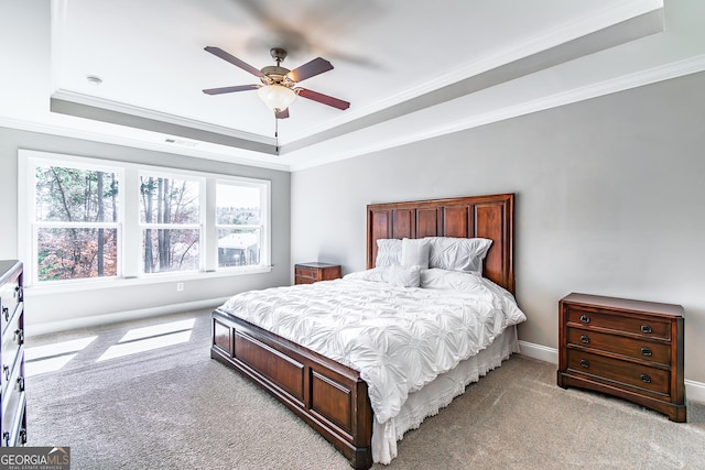 bedroom featuring ornamental molding, a raised ceiling, visible vents, and light colored carpet