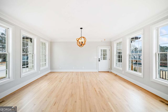 unfurnished sunroom with an inviting chandelier and a healthy amount of sunlight