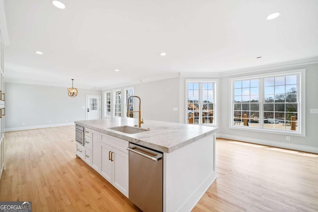 kitchen with white cabinetry, sink, hanging light fixtures, a kitchen island with sink, and stainless steel dishwasher