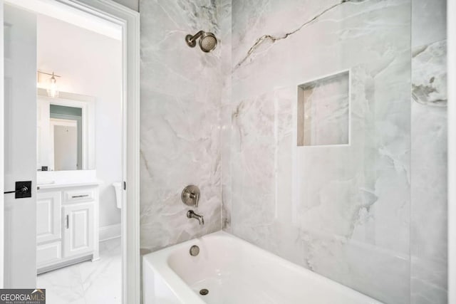 bathroom featuring vanity and tiled shower / bath