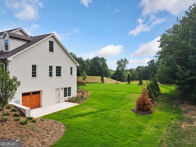 view of home's exterior with a garage and a yard