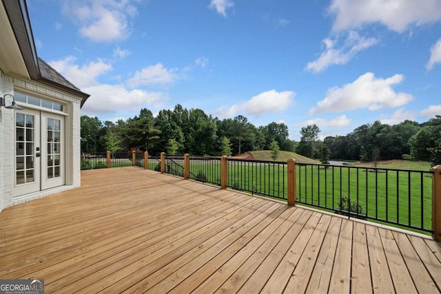 wooden deck with french doors and a lawn