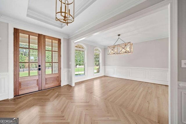 doorway to outside featuring an inviting chandelier, ornamental molding, parquet floors, and french doors