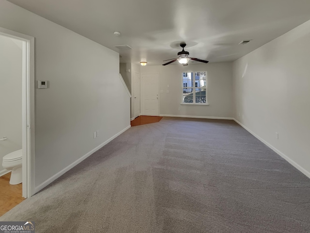 unfurnished living room with ceiling fan and carpet